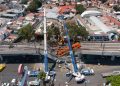 MEXICO CITY, MEXICO - MAY 04: Aerial view of the works to remove the damaged train after a train  overpass collapsed last night killing 23 people on May 04, 2021 in Mexico City, Mexico. The accident happened between Olivos and Tezonco stations of metro line 12 at 10pm local time. (Photo by Hector Vivas/Getty Images)
