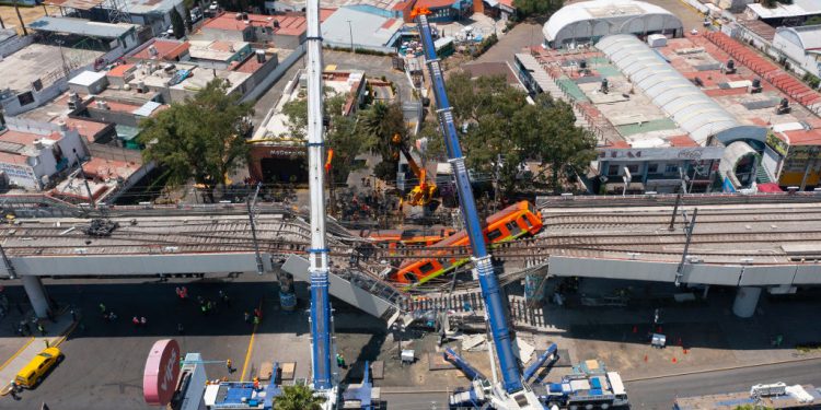MEXICO CITY, MEXICO - MAY 04: Aerial view of the works to remove the damaged train after a train overpass collapsed last night killing 23 people on May 04, 2021 in Mexico City, Mexico. The accident happened between Olivos and Tezonco stations of metro line 12 at 10pm local time. (Photo by Hector Vivas/Getty Images)